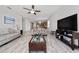 Open-concept living room and kitchen area with tile flooring and natural light at 17216 Goldcrest Loop, Clermont, FL 34714