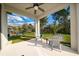 Enjoy the covered patio with ceiling fan, view of fenced yard with lush green grass at 17216 Goldcrest Loop, Clermont, FL 34714