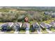Street view of the houses featuring lush green trees and landscaping at 17216 Goldcrest Loop, Clermont, FL 34714