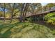 Landscaped backyard featuring lush green grass and mature trees at 1735 Foxhall Cir # 1735, Kissimmee, FL 34741
