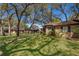 Attractive brick townhouse with a sidewalk, green lawn, and mature trees at 1735 Foxhall Cir # 1735, Kissimmee, FL 34741