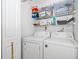 Laundry room with white washer and dryer and a wire rack shelf at 1735 Foxhall Cir # 1735, Kissimmee, FL 34741