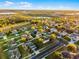 Expansive aerial view showcases a charming home nestled in a well-manicured neighborhood with lush landscaping at 1865 Sanderling Dr, Clermont, FL 34711