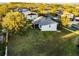 Aerial view of the home with a large backyard and proximity to neighborhood streets and houses at 1865 Sanderling Dr, Clermont, FL 34711