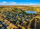 Beautiful aerial view of a residential neighborhood near a lake and green spaces on a clear and sunny day at 1865 Sanderling Dr, Clermont, FL 34711