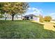 Large grassy backyard with a screened-in porch, providing a relaxing outdoor space at 1865 Sanderling Dr, Clermont, FL 34711