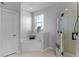 Bright bathroom featuring soaking tub under window and shower with glass door at 1865 Sanderling Dr, Clermont, FL 34711