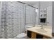 Bright bathroom featuring a single vanity, toilet, and shower with a decorative shower curtain at 1865 Sanderling Dr, Clermont, FL 34711