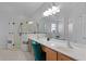 Bright bathroom featuring a double vanity, granite countertop, and large walk-in shower with glass enclosure at 1865 Sanderling Dr, Clermont, FL 34711