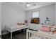 Bright bedroom with two twin beds, ceiling fan and lots of natural light at 1865 Sanderling Dr, Clermont, FL 34711