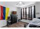 Bright bedroom with hardwood flooring and large window with blind and curtain at 1865 Sanderling Dr, Clermont, FL 34711