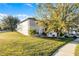 Spacious home with a well-kept lawn, mature trees, and a neatly trimmed garden at 1865 Sanderling Dr, Clermont, FL 34711