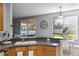 Kitchen boasts countertops, wooden cabinets, and a window offering backyard views at 1865 Sanderling Dr, Clermont, FL 34711
