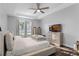 Bright main bedroom with tray ceiling, large window, and neutral decor at 1865 Sanderling Dr, Clermont, FL 34711