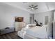 Bright main bedroom with tray ceiling, television, and exercise bike at 1865 Sanderling Dr, Clermont, FL 34711