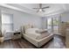 Bright main bedroom with tray ceiling, large window, and neutral decor at 1865 Sanderling Dr, Clermont, FL 34711