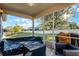 Enclosed patio featuring a covered couch and natural lighting at 1865 Sanderling Dr, Clermont, FL 34711