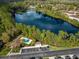 Scenic aerial view of community pool, lake, parking, and surrounding lush greenery at 2015 Shalimar Loop, Sanford, FL 32773