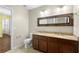 Bathroom features a double vanity with granite countertop and decorative mirror at 2015 Shalimar Loop, Sanford, FL 32773