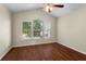 Bright bedroom features a ceiling fan, hardwood floors, and large windows for ample natural light at 2015 Shalimar Loop, Sanford, FL 32773
