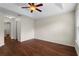 Bedroom featuring hardwood floors, a ceiling fan, and a view into the hallway at 2015 Shalimar Loop, Sanford, FL 32773