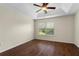 Bedroom with hardwood floors, tray ceiling, ceiling fan, and a window with natural light at 2015 Shalimar Loop, Sanford, FL 32773