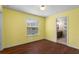 Sunny bedroom with wood floors and an adjacent bathroom at 2015 Shalimar Loop, Sanford, FL 32773