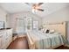 Comfortable bedroom with a ceiling fan, a large window with blinds, and beach-themed decor at 2015 Shalimar Loop, Sanford, FL 32773