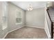 Dining room with decorative chandelier, neutral walls, and tile flooring near the staircase at 2015 Shalimar Loop, Sanford, FL 32773