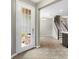 Light-filled entryway with decorative glass door, tile flooring, and view of the staircase at 2015 Shalimar Loop, Sanford, FL 32773