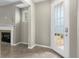 This cozy entryway features a glass paneled door and a fireplace with white mantle at 2015 Shalimar Loop, Sanford, FL 32773