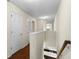 Upstairs hallway with hardwood floors and white trim, leading to various rooms at 2015 Shalimar Loop, Sanford, FL 32773