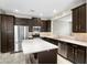 Modern kitchen features dark cabinets, stainless steel appliances, and a bright white countertop island at 2015 Shalimar Loop, Sanford, FL 32773
