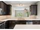 Spacious kitchen with granite counters, dark wood cabinets and stainless steel appliances overlooking the living room at 2015 Shalimar Loop, Sanford, FL 32773
