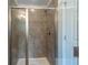 Walk-in shower featuring gray tile and glass enclosure at 2015 Shalimar Loop, Sanford, FL 32773