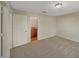 Bedroom featuring neutral walls and gray carpeting with a peek into the adjoining bathroom at 209 Fig Ct, Kissimmee, FL 34759