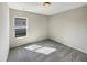 A cozy bedroom with neutral walls, carpeting, and a sunlit window at 209 Fig Ct, Kissimmee, FL 34759