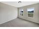 Bright, carpeted bedroom with two windows offering pleasant neighborhood views at 209 Fig Ct, Kissimmee, FL 34759