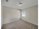 Carpeted bedroom featuring neutral walls and a window showcasing the tranquil backyard at 209 Fig Ct, Kissimmee, FL 34759