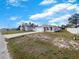 Charming one-story home with a well-maintained front yard, featuring a long driveway and an attached two-car garage at 209 Fig Ct, Kissimmee, FL 34759