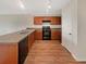 Efficient kitchen layout with wood cabinets, black appliances, and ample counter space, providing a functional cooking area at 209 Fig Ct, Kissimmee, FL 34759
