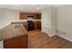 The kitchen features wood cabinets, a black oven, stainless steel sink, and wood-look flooring at 209 Fig Ct, Kissimmee, FL 34759