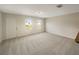 Bright, carpeted living room with lots of natural light, showing a blank canvas for you to personalize and enjoy at 209 Fig Ct, Kissimmee, FL 34759