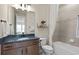 Modern bathroom boasts wood cabinets, neutral tiling, and a combined shower and tub at 2141 Weatherly Way, Orlando, FL 32820