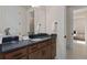 Bathroom boasts wood cabinetry, granite countertop, and access to the bedroom at 2141 Weatherly Way, Orlando, FL 32820