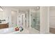 Bright bathroom with a soaking tub, glass-enclosed shower, and modern design elements at 2141 Weatherly Way, Orlando, FL 32820
