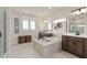 Bright bathroom with a soaking tub, dual vanities, and elegant décor accents at 2141 Weatherly Way, Orlando, FL 32820