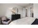 Bright bedroom showcasing view to ensuite bath and closet, neutral palette, accent chair at 2141 Weatherly Way, Orlando, FL 32820