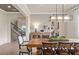 Stylish dining room with wooden table, modern lighting, and elegant furnishings at 2141 Weatherly Way, Orlando, FL 32820