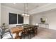Dining room with wooden table, modern lighting, and elegant black and white accents at 2141 Weatherly Way, Orlando, FL 32820